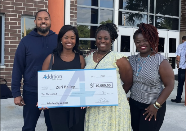 Senior Zuri Bailey poses with a check from Addition Financial. Over 70 students were recognized on May 1 at the scholarship breakfast. Photo by Zuri Bailey.